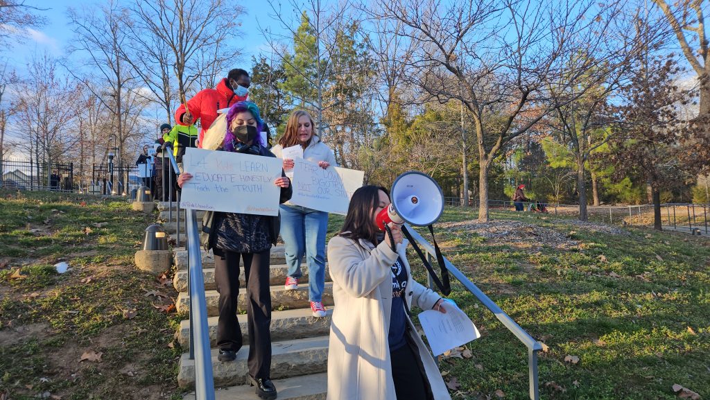 Mitch, Hamkae Center's Organizing Team Lead, leads a crowd holding signs at the Rally to Stop Whitewashing Virginia History just before the History SOLs Town Hall at Mount Vernon, VA on March 14, 2023.